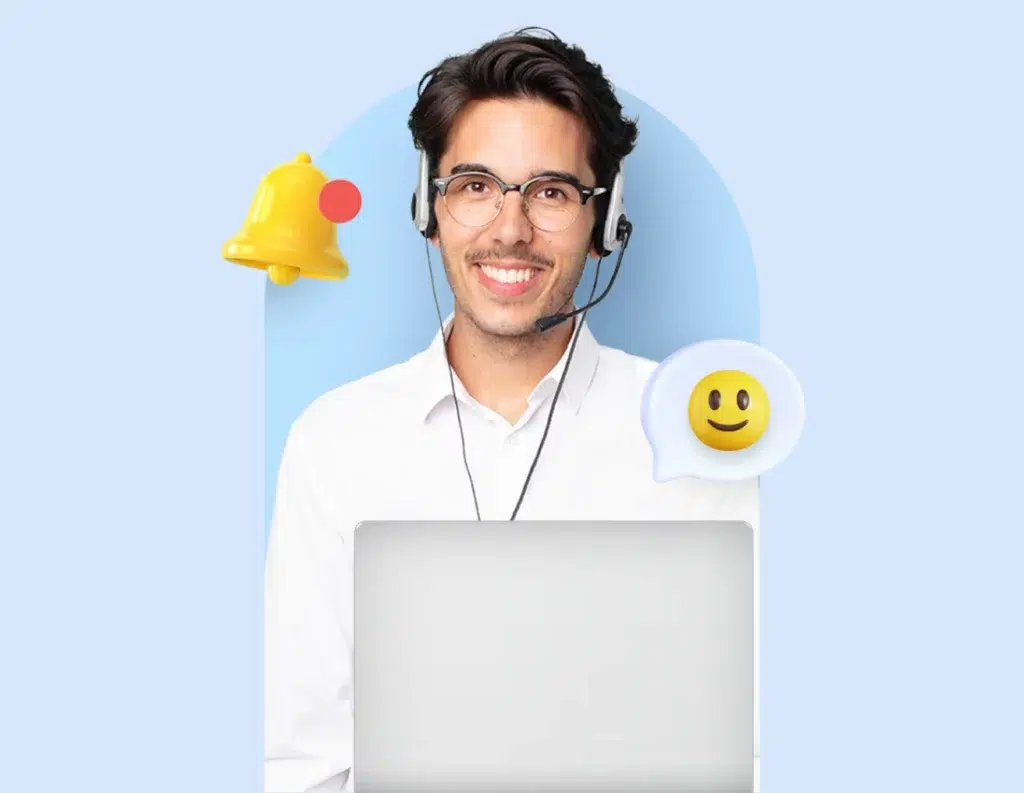 Seorang pria mengenakan headphone duduk di depan laptop, dikelilingi oleh ikon lonceng dan emotikon senyum, menunjukkan suasana kerja yang ceria.