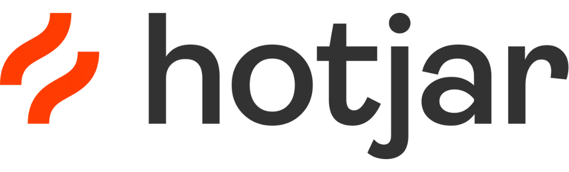 Logo Hotjar tampil dengan teks "hotjar" dalam warna abu-abu, disertai dua garis melengkung merah di atasnya. Logo ini sering digunakan dalam konteks analisis web dan pengalaman pengguna.