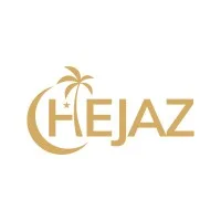 Logo berwarna emas bertuliskan "HEJAZ" dengan ikon bulan sabit dan pohon palem, menciptakan kesan elegan dan bernuansa tropis.