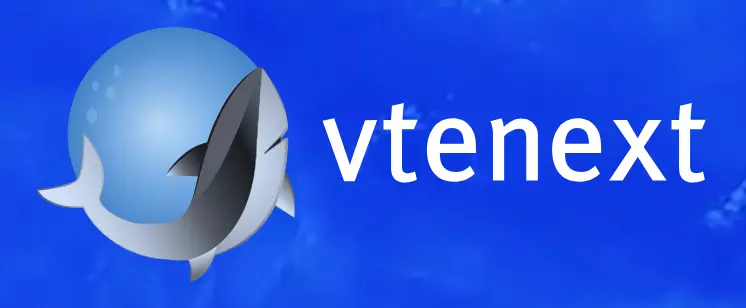 Logo biru dengan ikan dan tulisan "vtenext" menunjukkan identitas merek yang berfokus pada teknologi atau layanan digital, dalam latar belakang laut.
